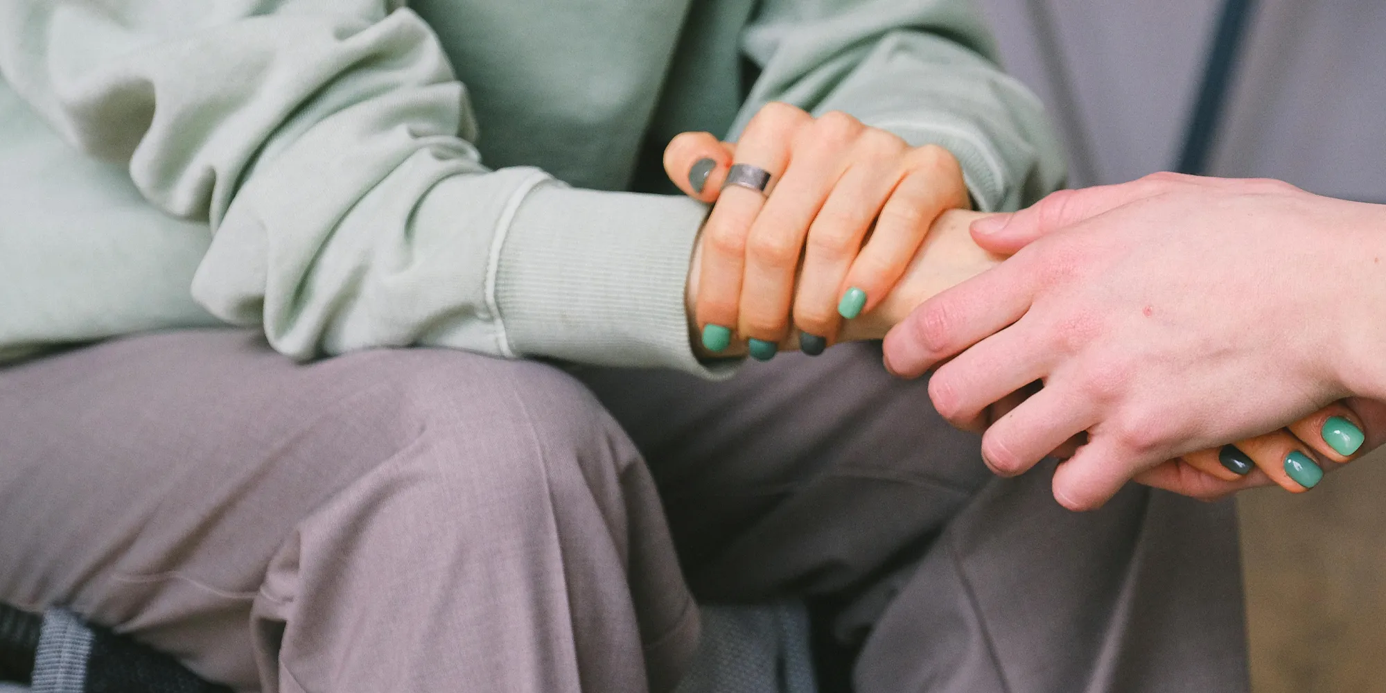 mother holding daughter's hands