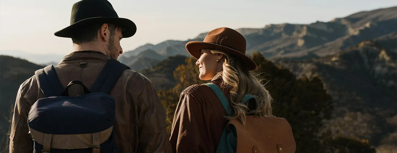 couple in cowboy hats out in nature